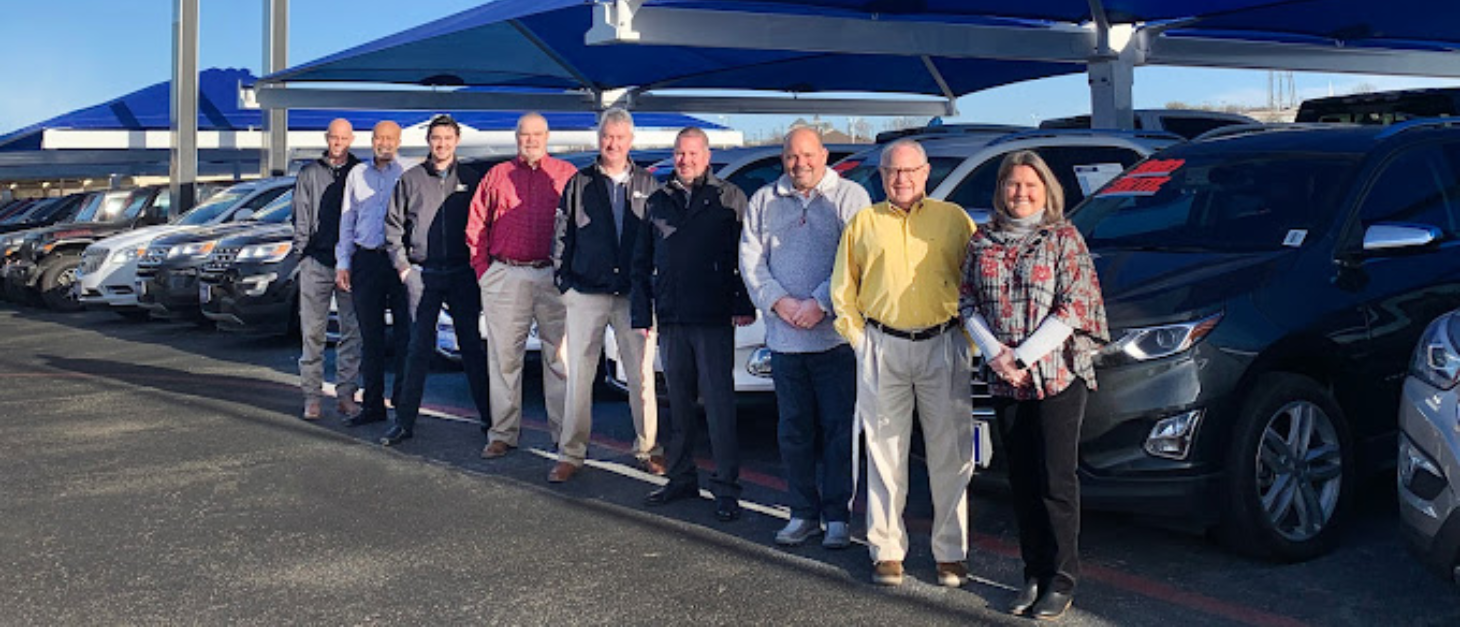James wood team standing next to cars