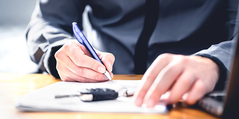 James Wood Motors Decatur in Decatur TX customer signing financing paperwork